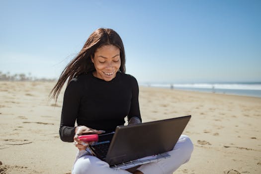 a person relaxing with a laptop on a beach