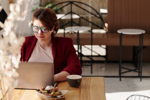 A digital nomad using her laptop in a cozy coffee shop