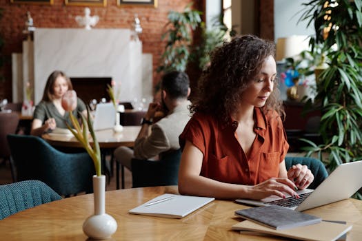 a freelancer working on a laptop in a cozy café