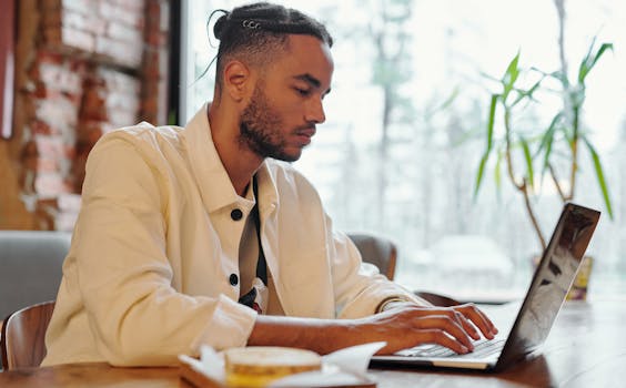 Freelancer working on laptop in a cozy cafe