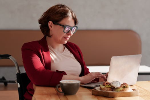 digital nomad working on laptop in a cafe